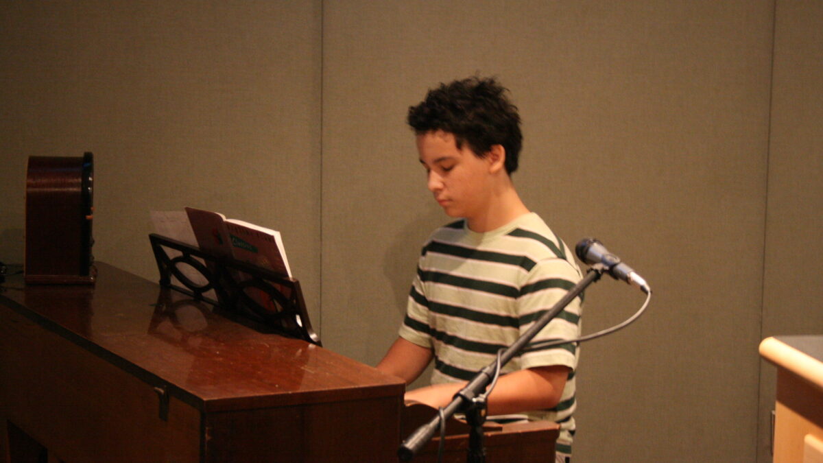 2010-09-18-SatShowPics 001 A teen playing a piano in a radio studio