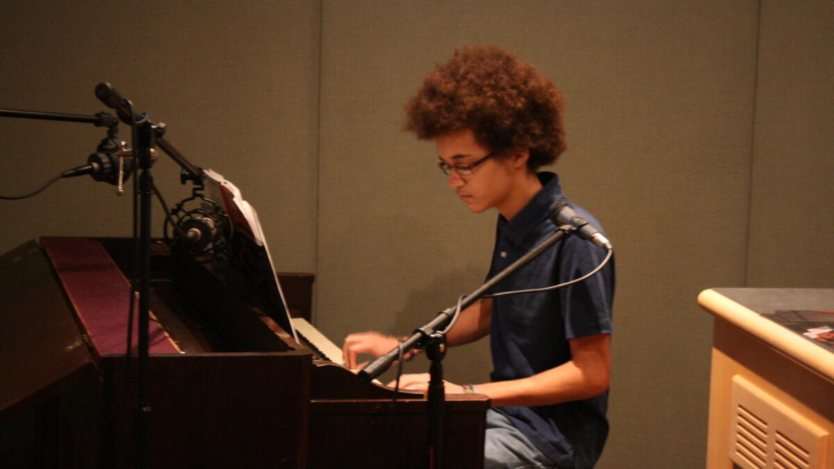 2010-09-18-SatShowPics 002 A teen playing a piano in a radio studio