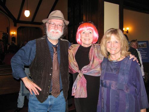 Three adults smiling and posing in profile