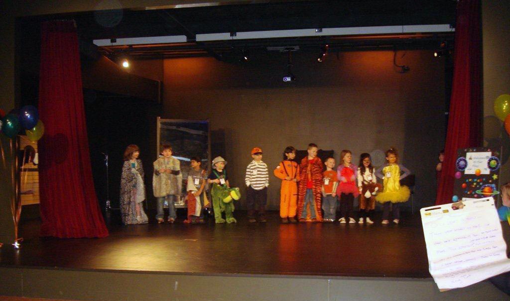 Multiple youth standing on a stage