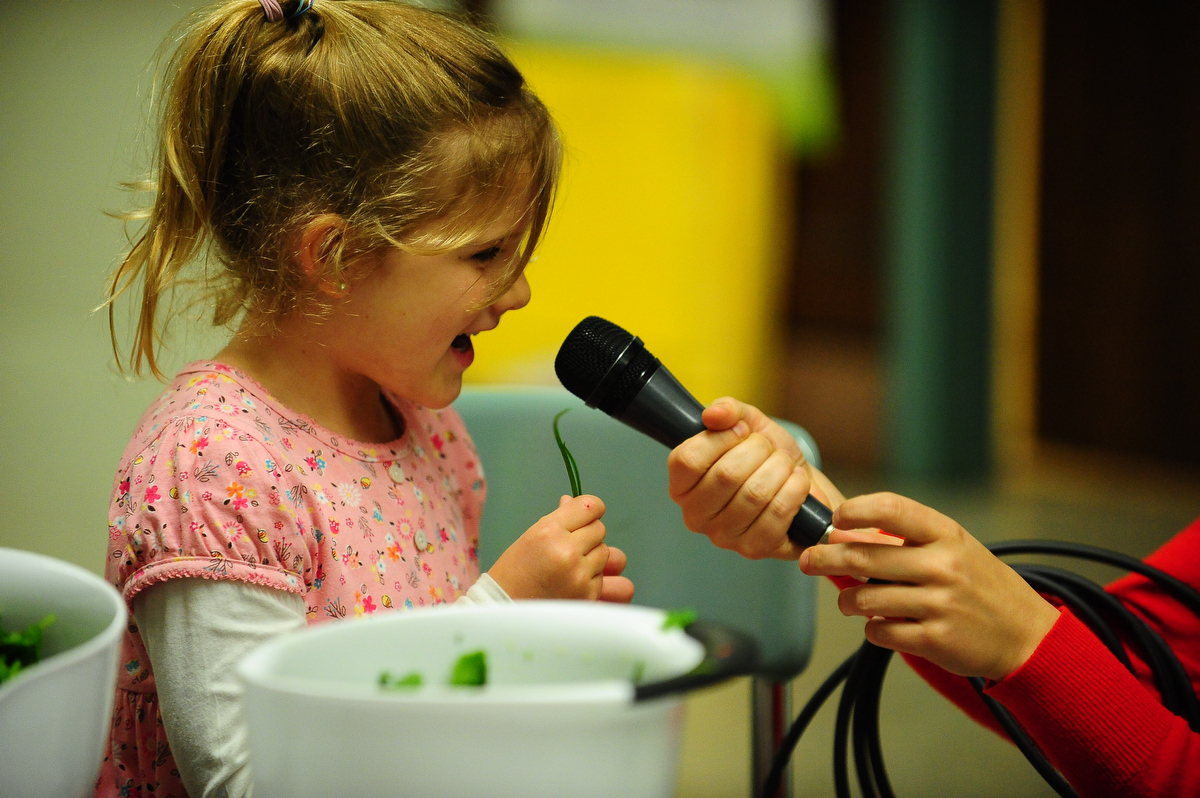 A youth speaking into a held microphone