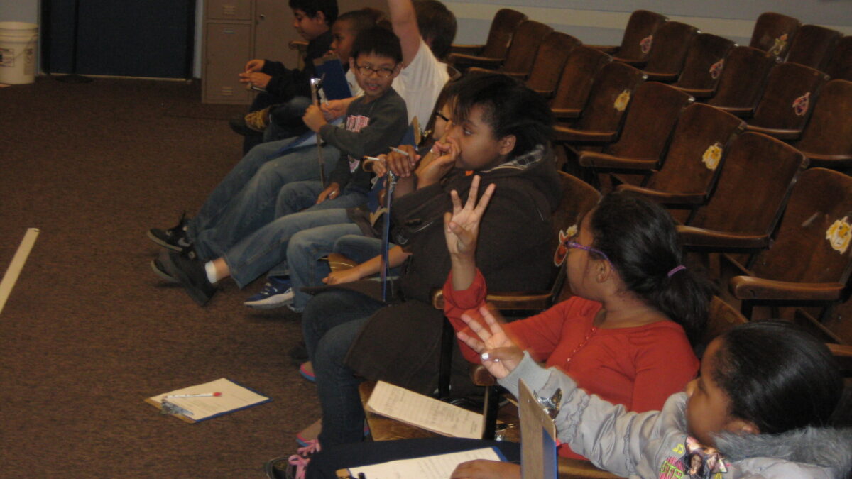 Pittsburgh Spring Hill 2013 Eight youth sitting in auditorium seats, three holding up their hands