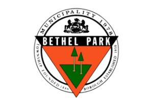 A circular logo of an orange triangle with a green triangle and two simple graphics of trees inside, along with the text "Bethel Park" in white on a black background above