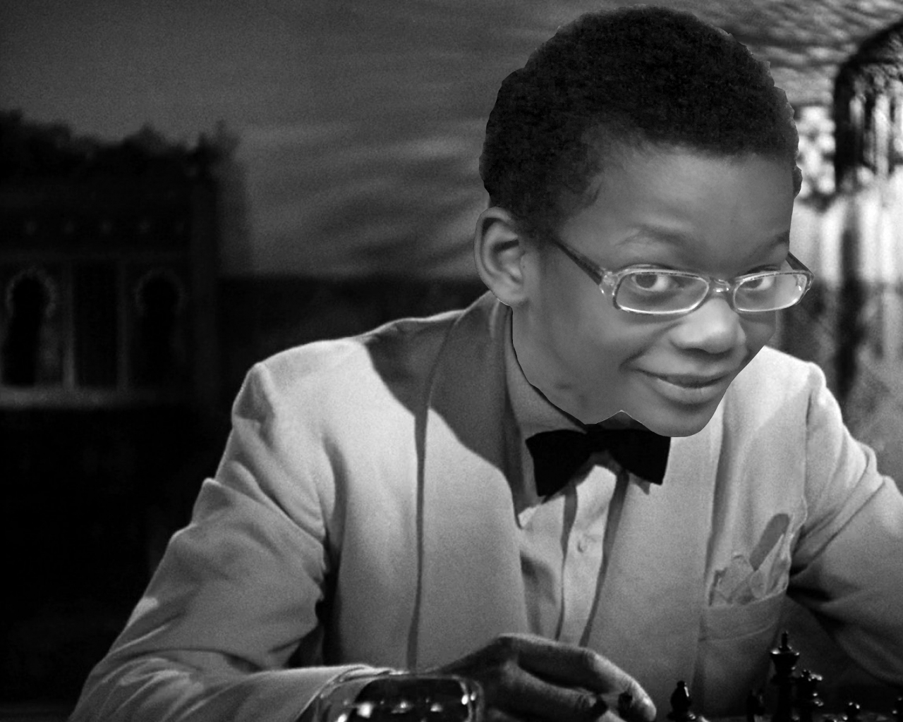 A black and white image of an adult wearing a suit and a bow tie, with a child's head photoshopped on