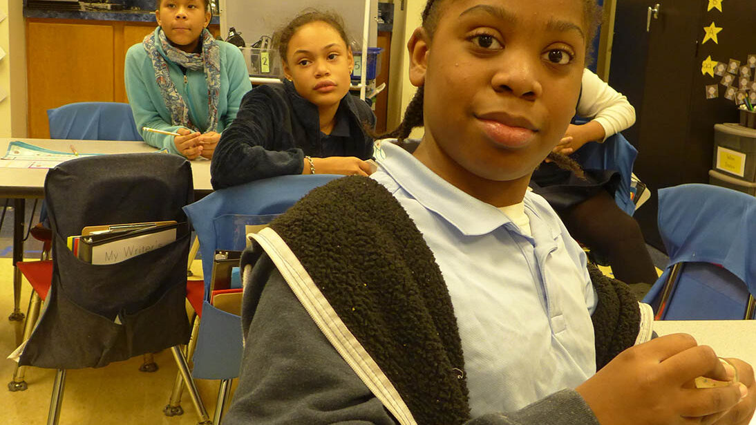 Three youth sitting in a classroom