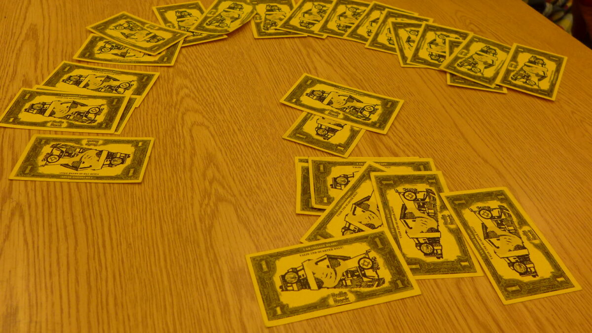 A collection of board game bills on a wooden table