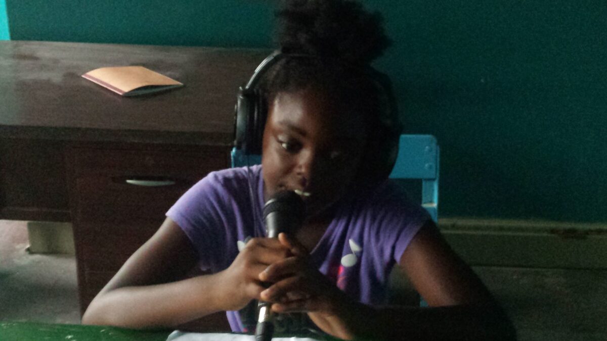 20160728_114536 A youth wearing headphones speaking into a microphone