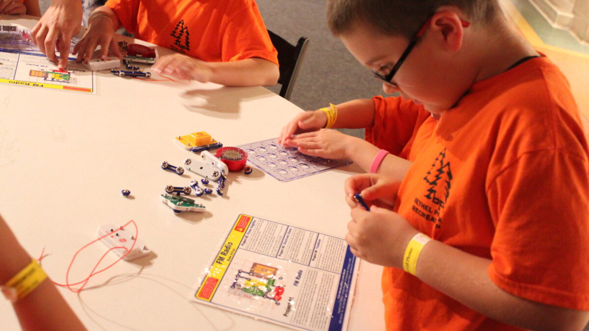 Two youth playing with snap circuits