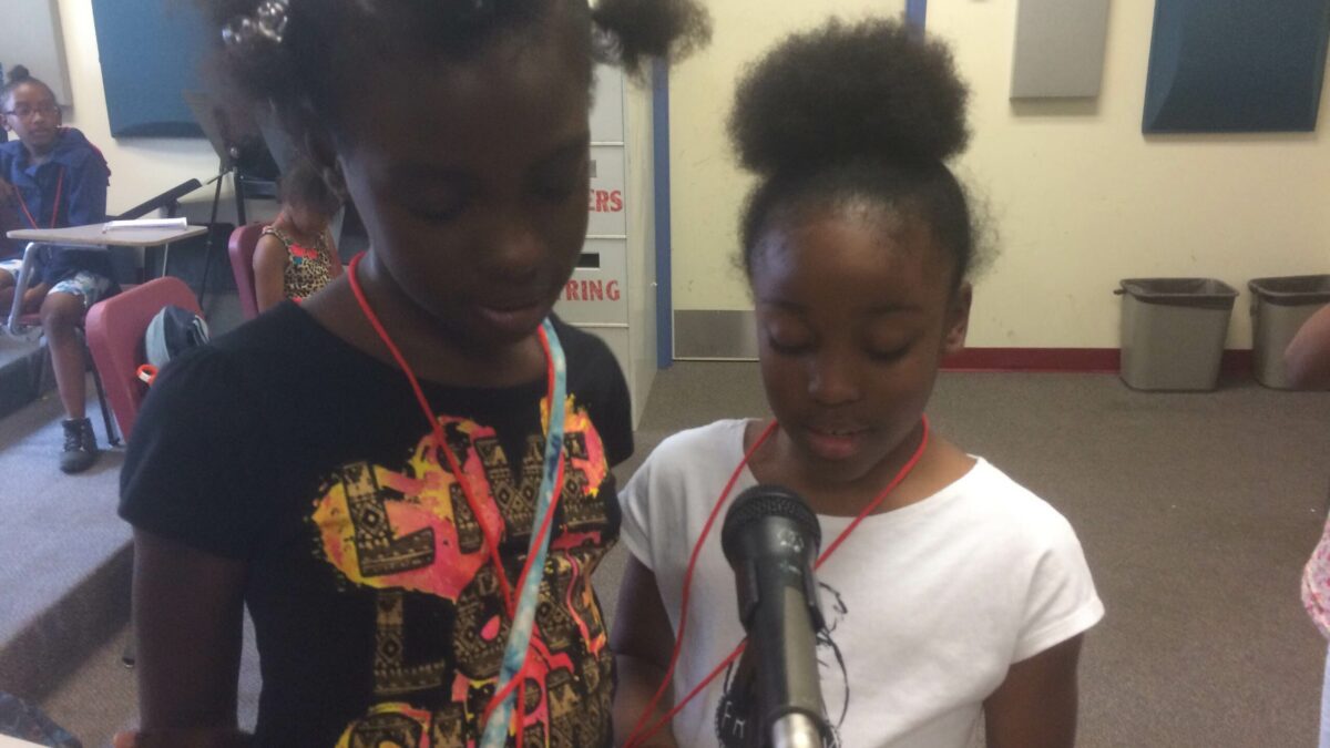 IMG_3141 Two youth speaking into a microphone in a classroom