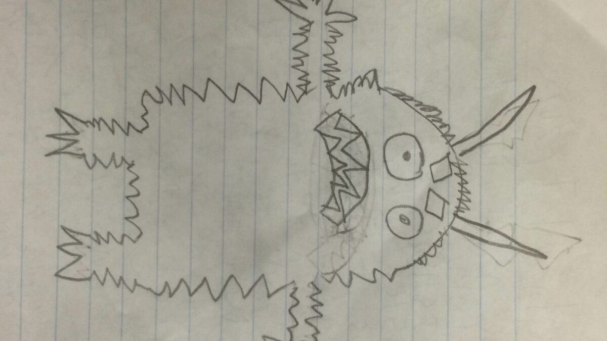 A drawing of a monster on a piece of notebook paper