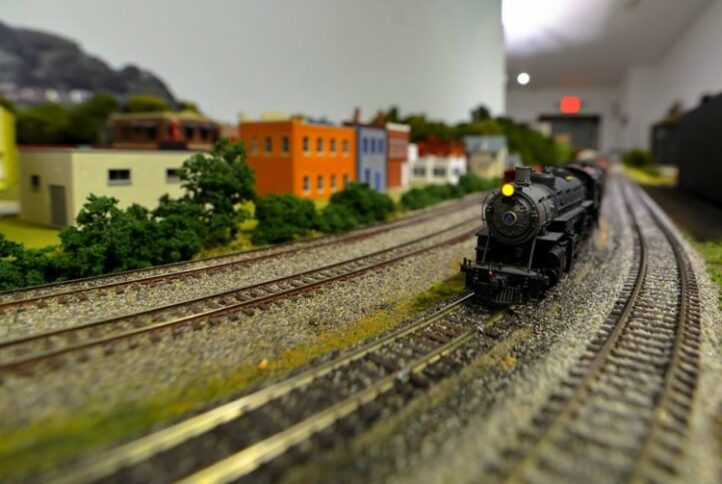 A model train passing by a model city