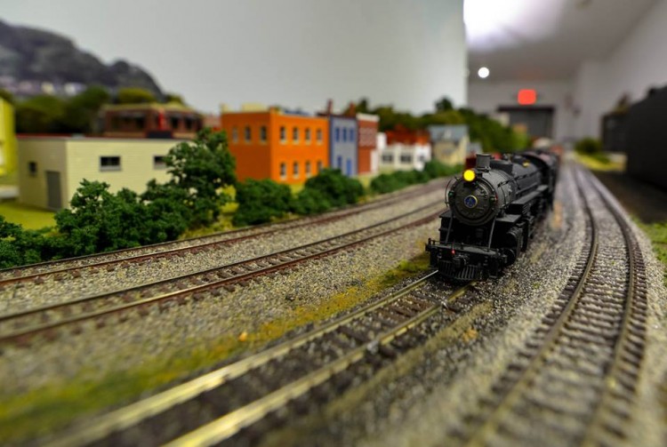 A model train passing by a model city