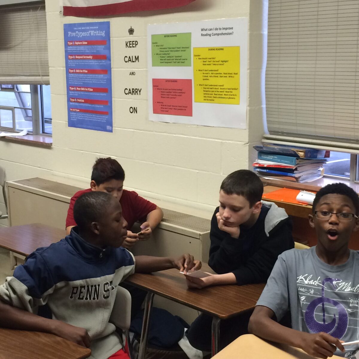 Four youth sitting at classroom desks