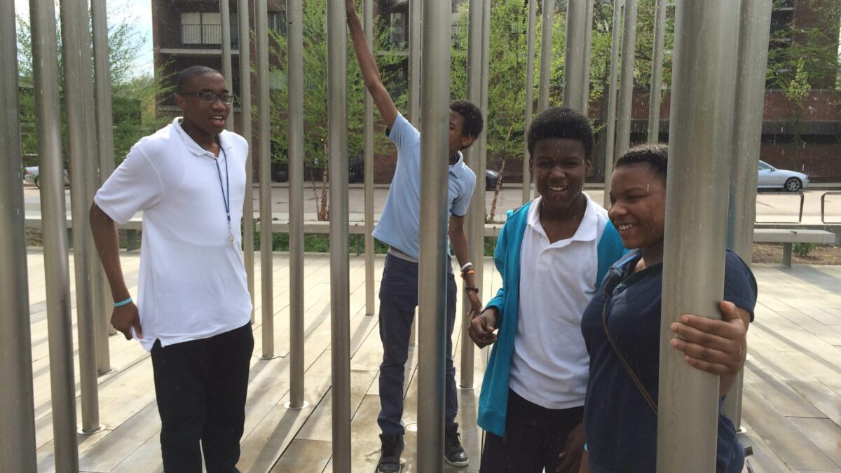 IMG_1118 Four youth standing in the midst of poles
