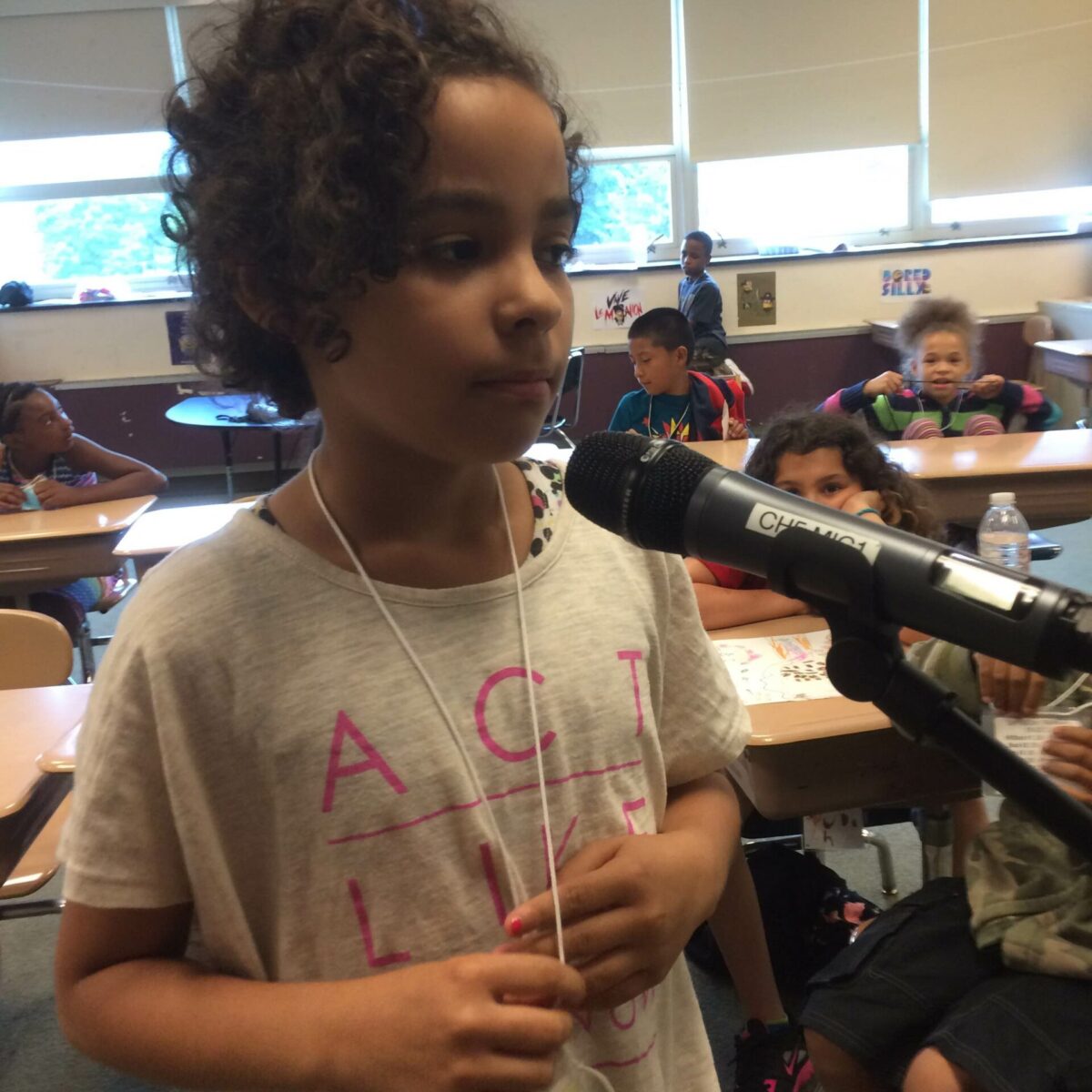 IMG_1317 A youth standing behind a microphone in a classroom