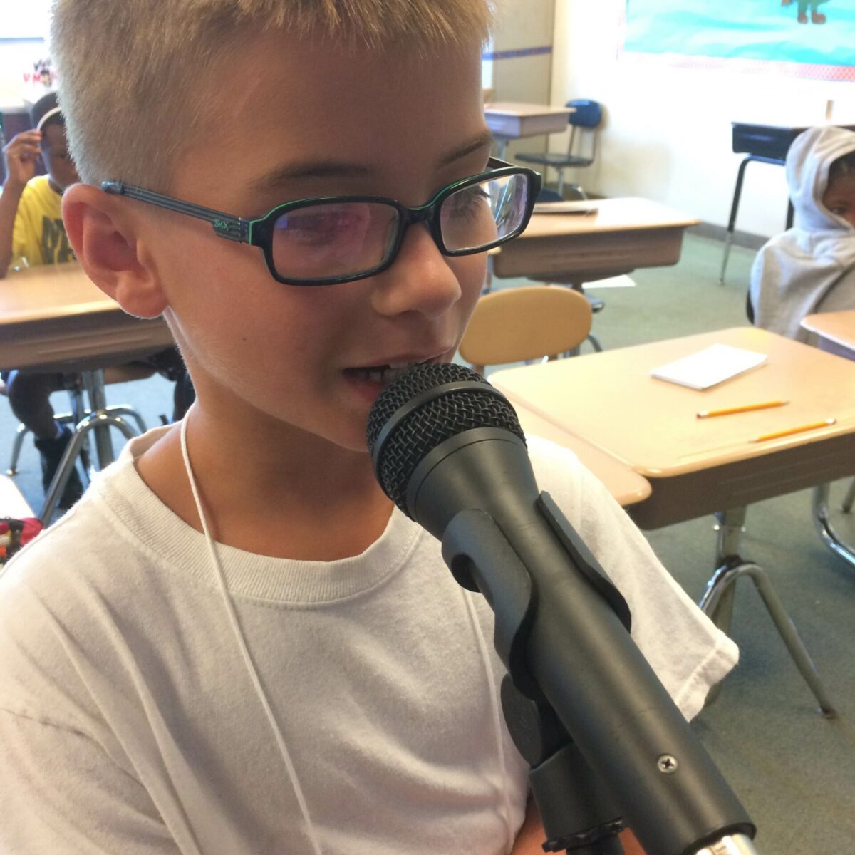 IMG_1481 A youth speaking into a microphone in a classroom