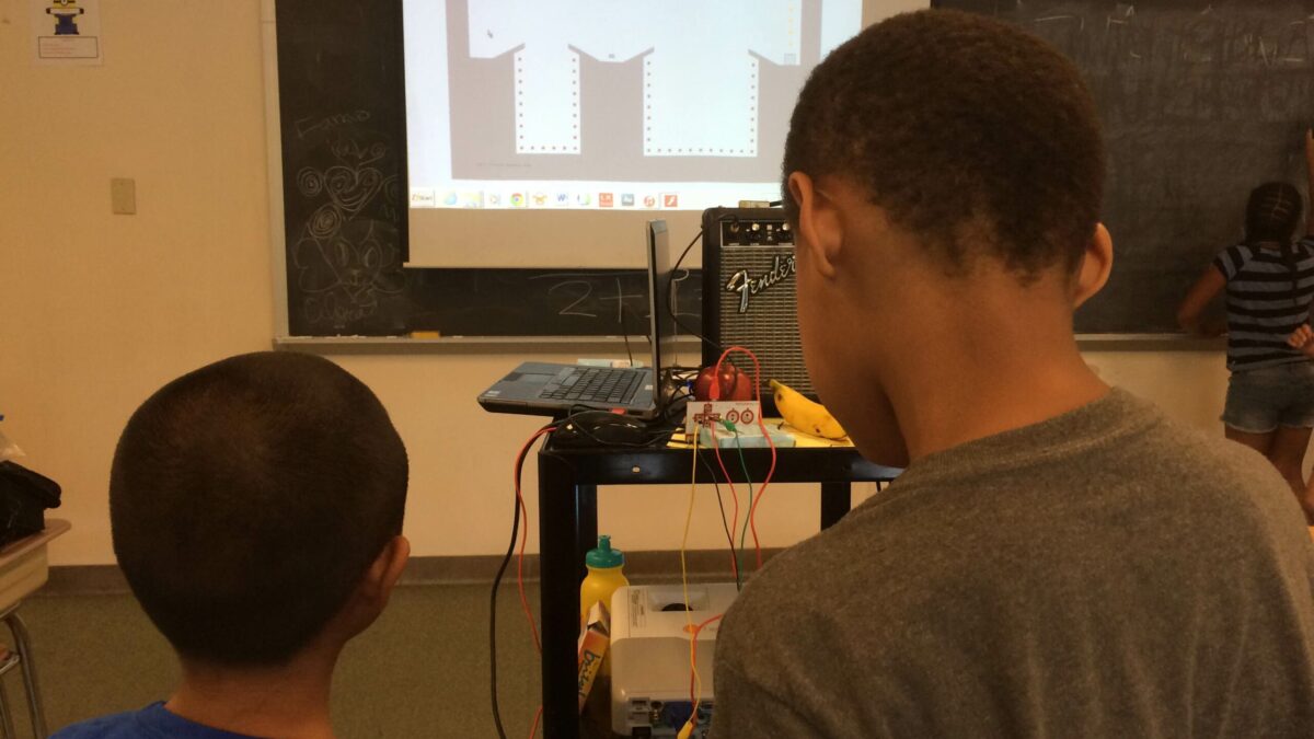 Two youth looking at a projected screen in a classroom