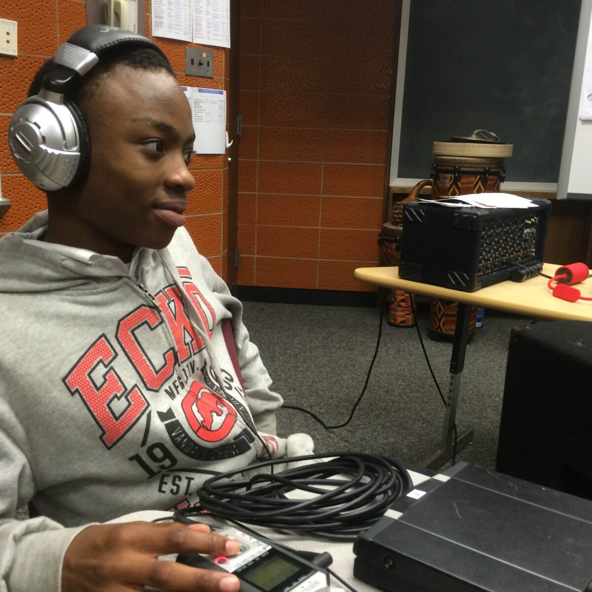 IMG_1720 A youth wearing headphones sitting behind a portable recorder on a classroom desk