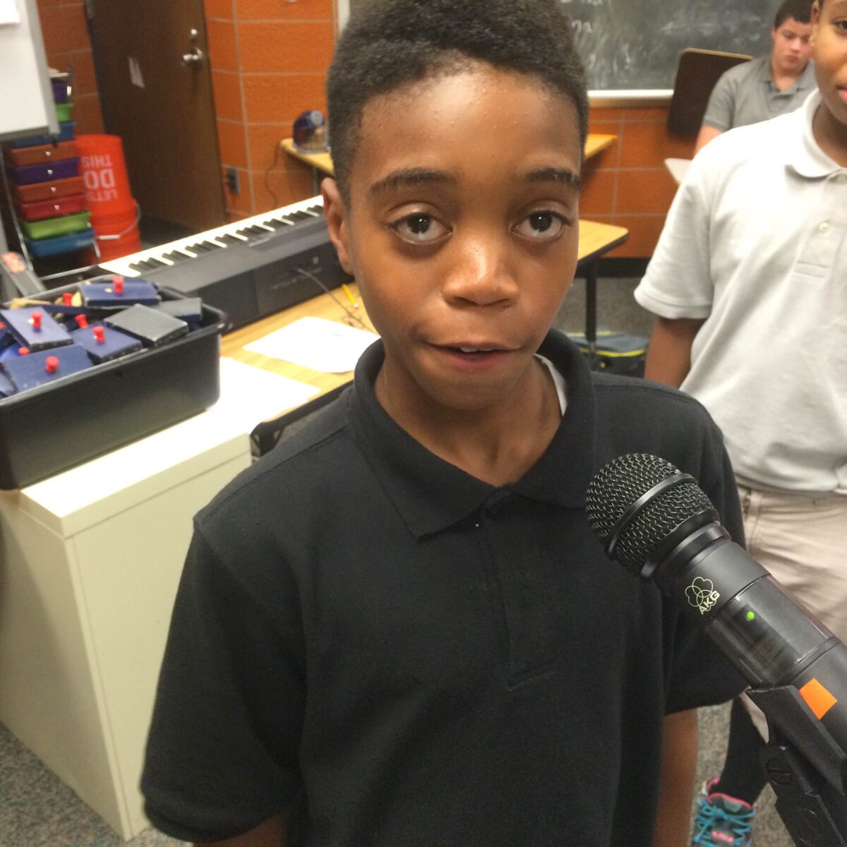 IMG_1729 A youth speaking into a microphone in a classroom