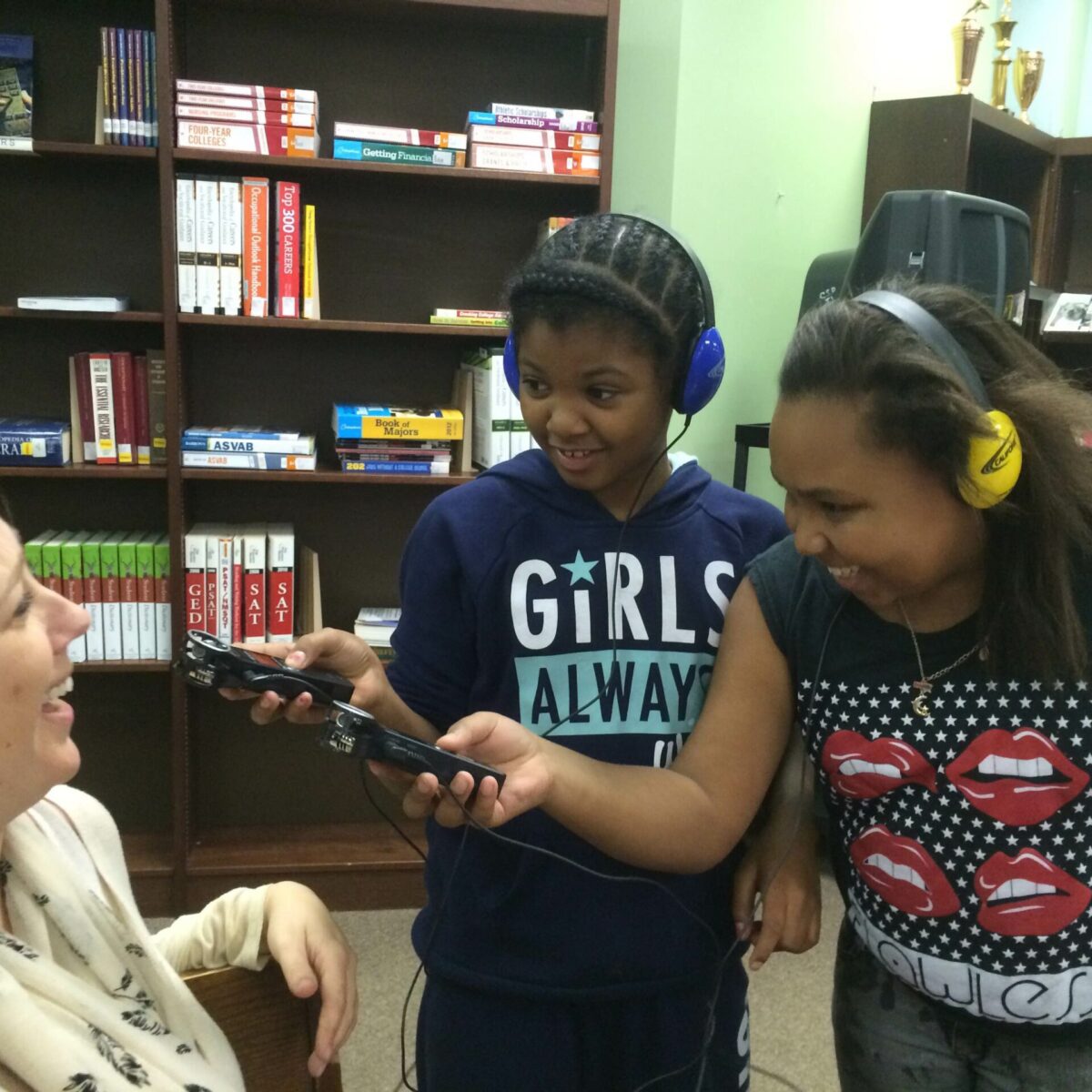 IMG_1929 Two youth wearing headphones holding portable recorders at a laughing adult
