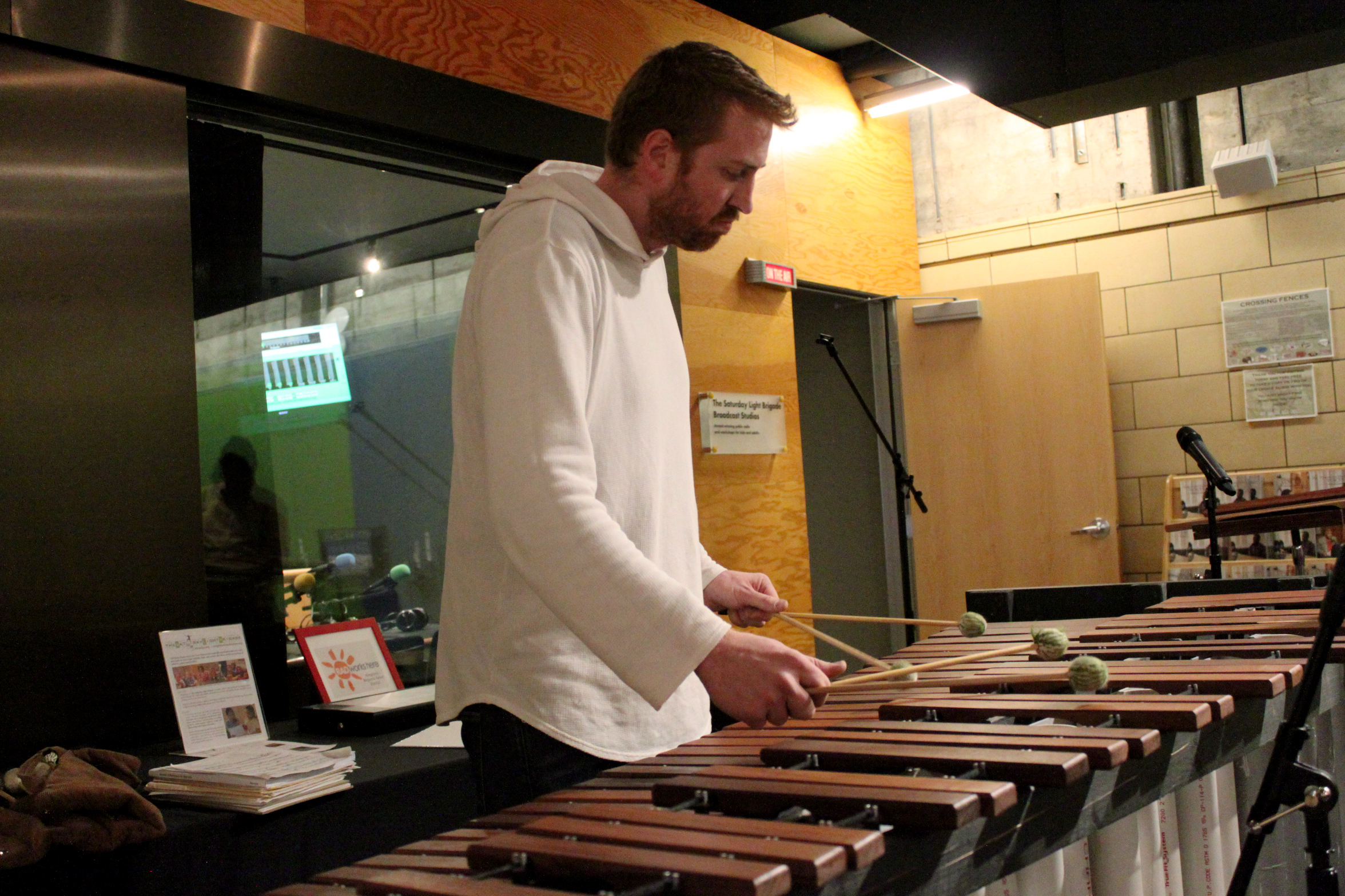 An adult playing a marimba