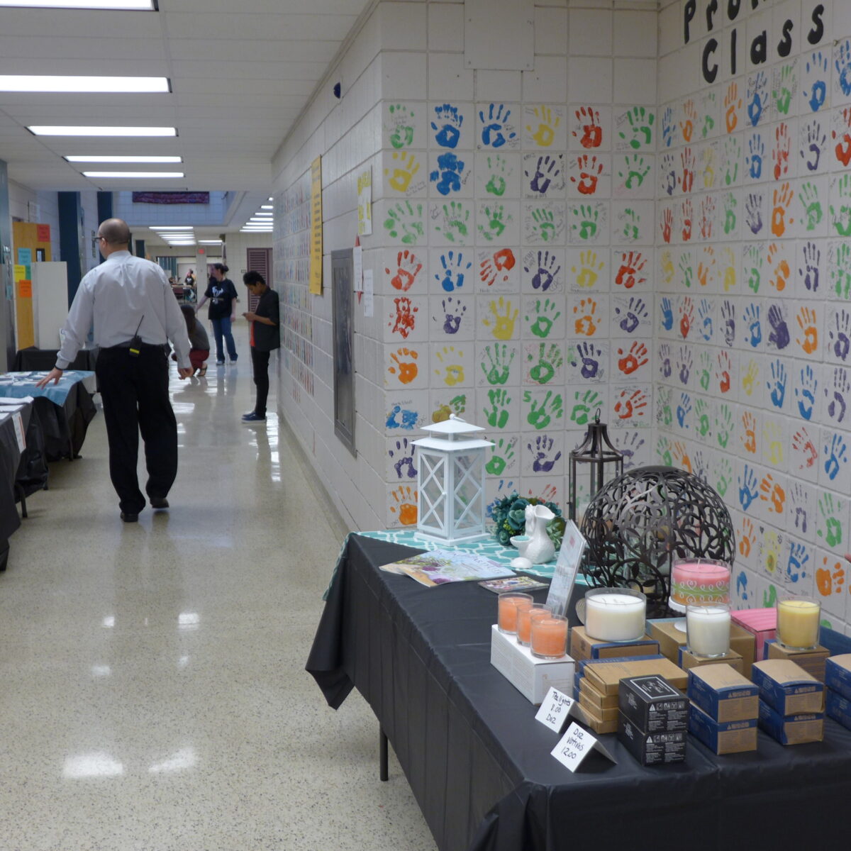 A school hallway with multicolored handprints all over the wall