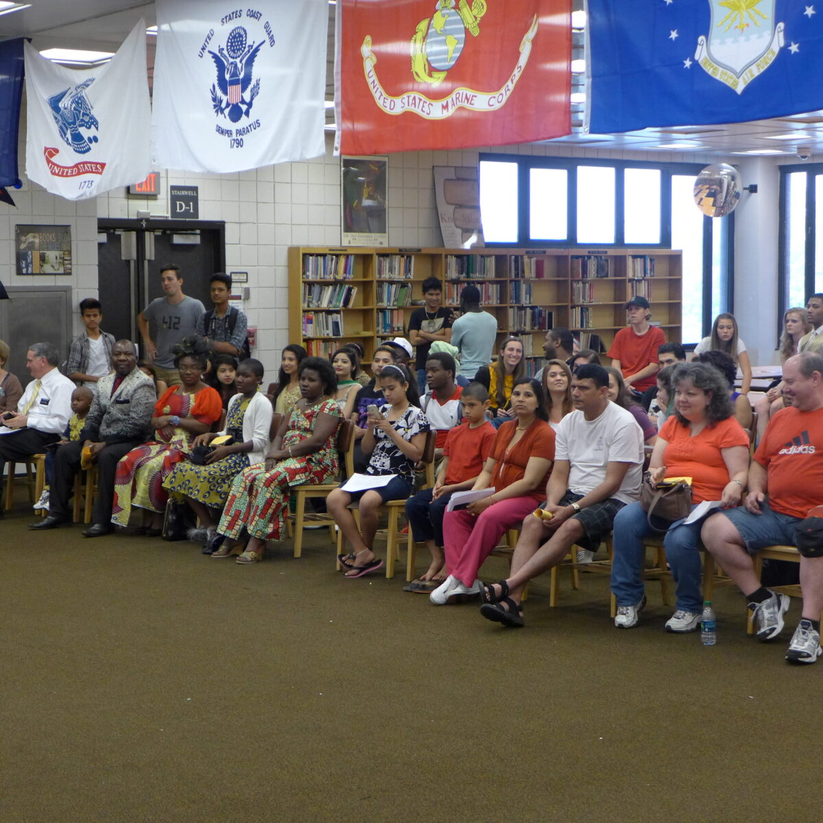 An audience of people sitting in a library