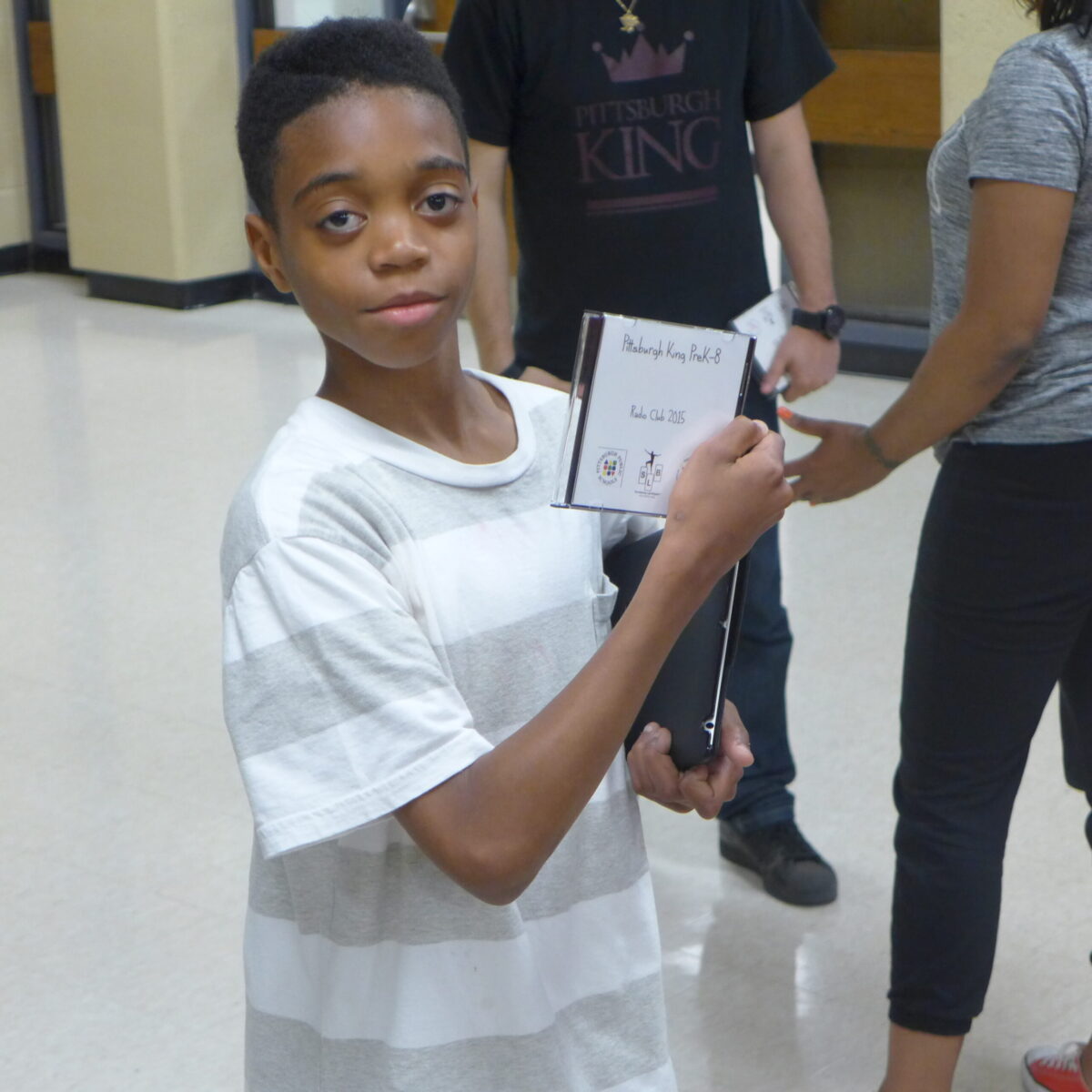 P1020687 A youth holding up a cd case and looking at the camera