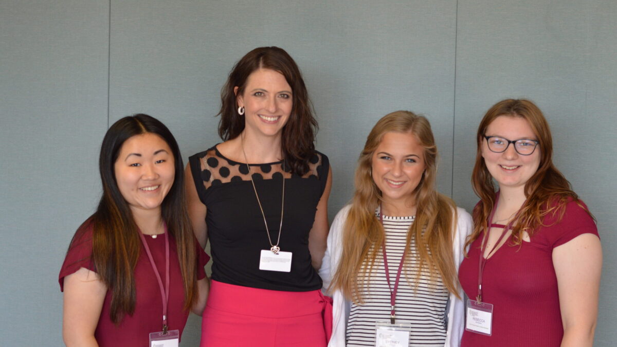 Three teens and one adult smiling and posing in profile