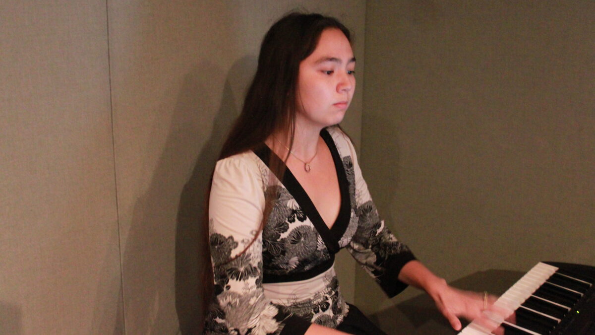 Youth playing a piano in a radio studio