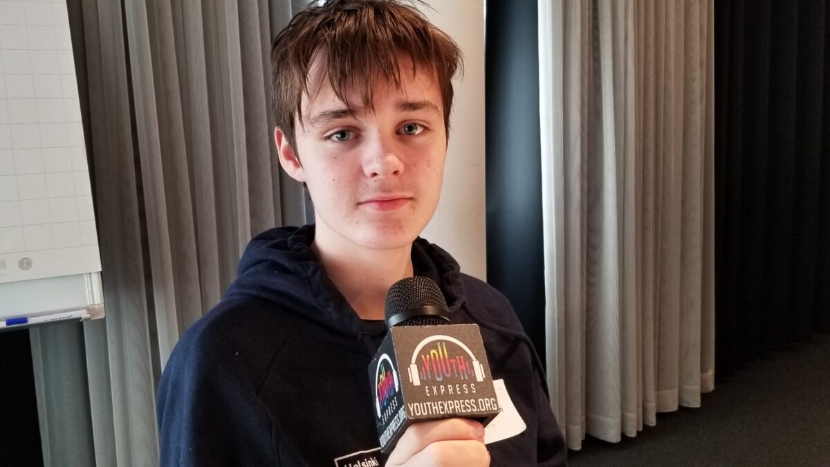 Young adult holding a microphone and posing in profile