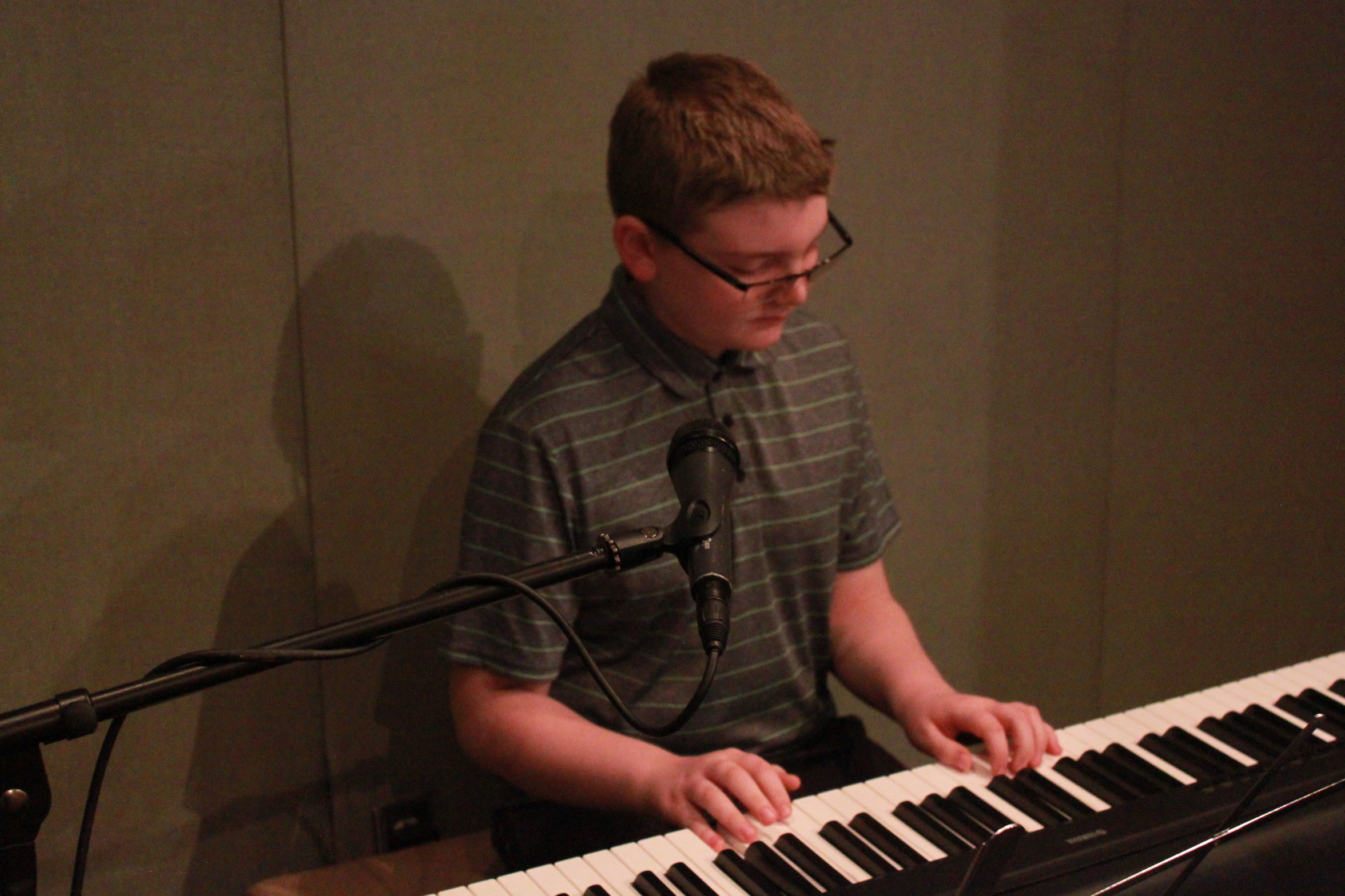 Youth playing a piano keyboard