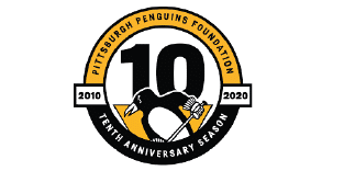 A circular logo with the number 10 and a graphic of a cartoon penguin wearing hockey gloves and holding a hockey stick inside, with a black and gold border with the text "Pittsburgh Penguins Foundation" in black on the gold part, and "Tenth Anniversary Season" in white on the black part