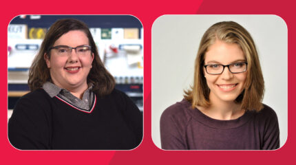 Two adults with brown hair and glasses smiling in profile