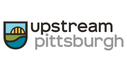A simplistic graphic of a bridge overlooking a stream of water, with the text "upstream" in black and "pittsburgh" in gray, all on a white background