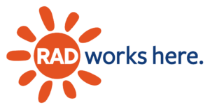 The text "RAD" in white surrounded by an orange sun and the text "works here" in blue to the right written on a white background