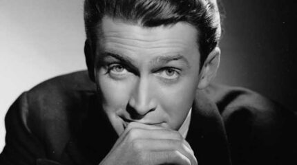 Black and white picture of an adult with hand in front of mouth