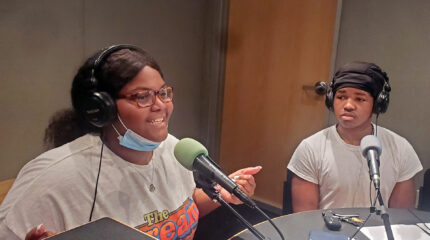 two teens having a conversation in a radio studio