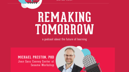 adult in business attire and glasses profiled on light background