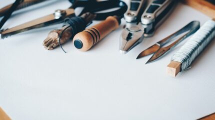 A collection of tools on a thin blank white canvas