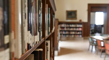 A close up shot of a bookshelf in a library