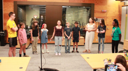 Ten youth singing in a choir