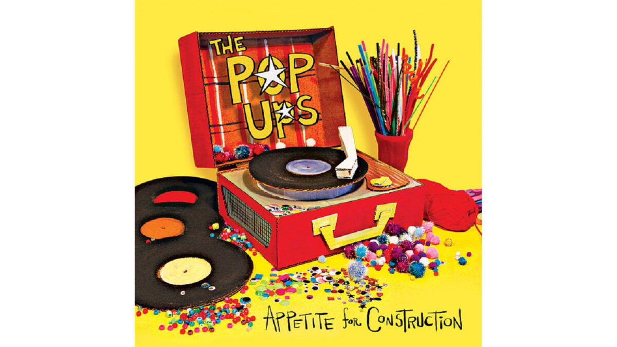 'Appetite_For_Construction'_Album_Cover_wp A red record player with three records on the left and red yarn on the right, along with the text "The Pop Ups" in yellow in front of the lid of the record player, and "Appetite for Construction" in black print underneath, all on a yellow background