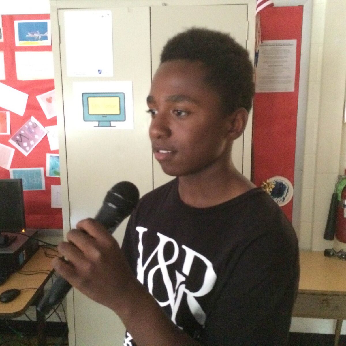IMG_1057 A youth holding and speaking into a microphone