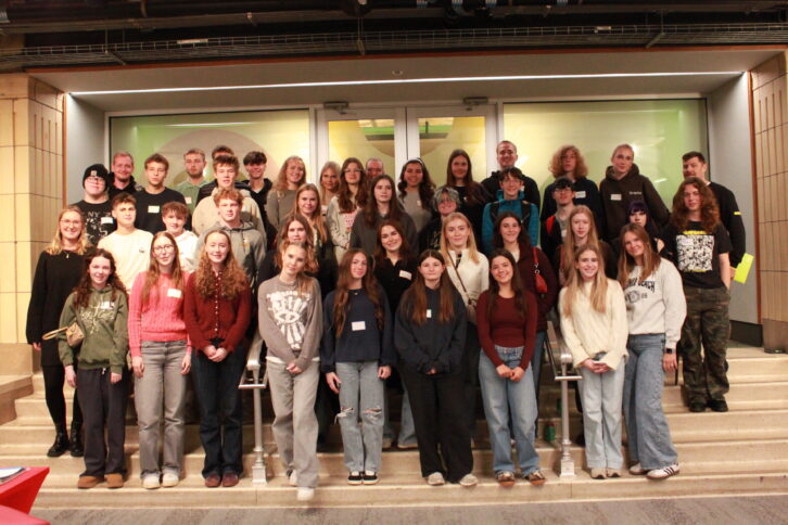 Forty one teens and one adult smiling while standing on a staircase