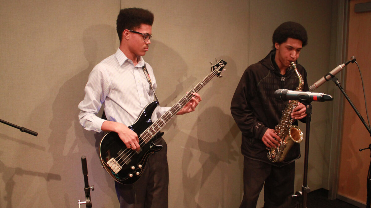 IMG_7878_wp A teen playing electric bass and a teen playing alto saxophone in a radio studio