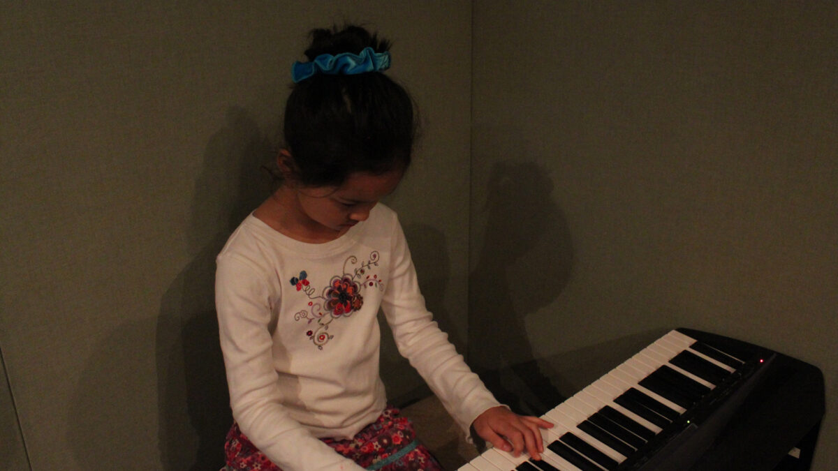 IMG_8438_wp A youth playing a piano keyboard in a radio studio