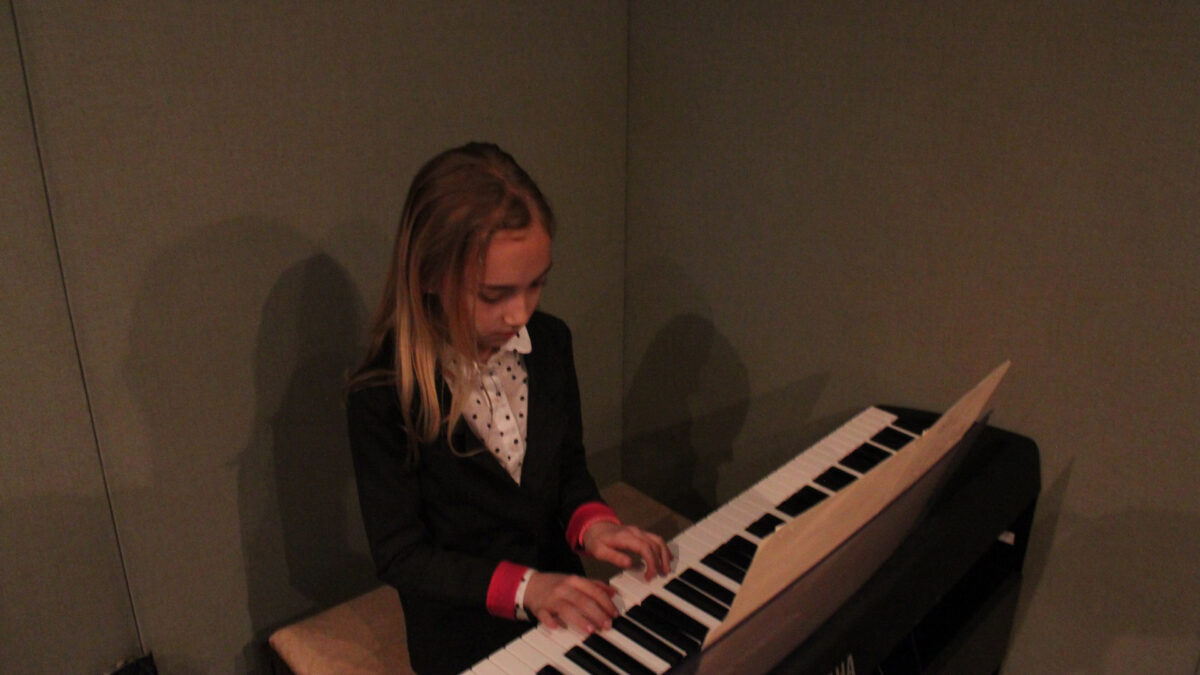 IMG_8441_wp A youth playing a piano keyboard in a radio studio