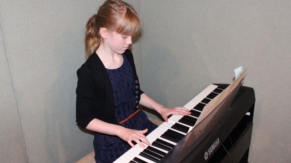 IMG_8443_wp A youth playing a piano keyboard in a radio studio