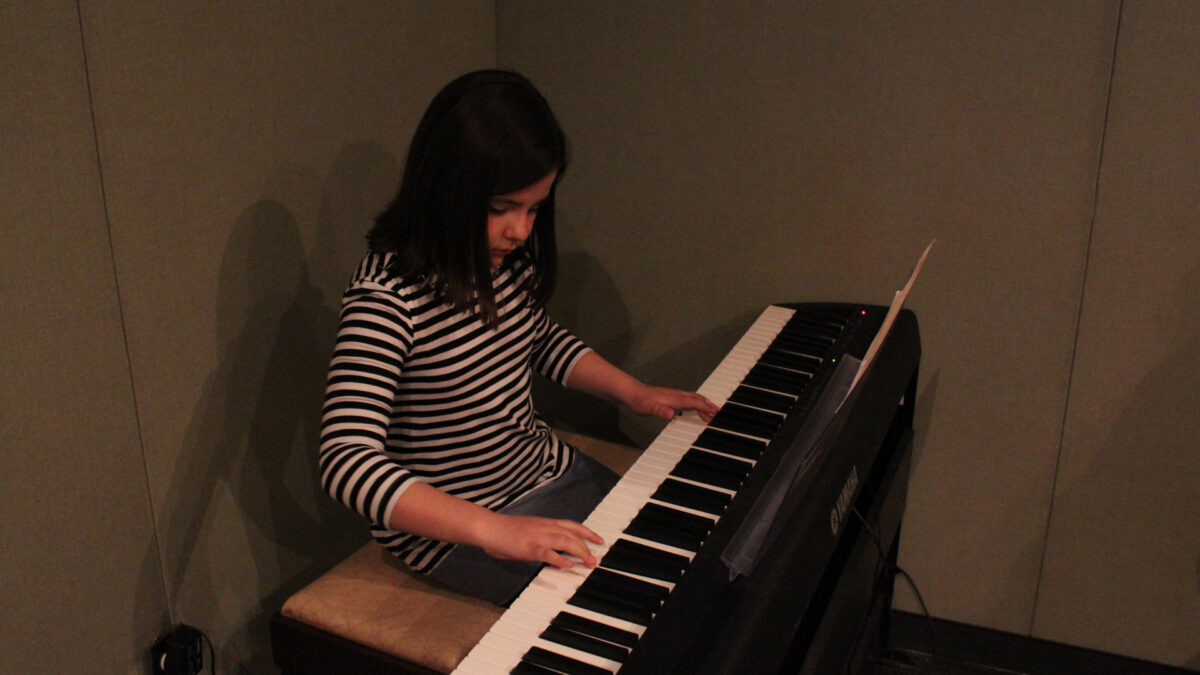 IMG_8444_wp A youth playing a piano keyboard in a radio studio